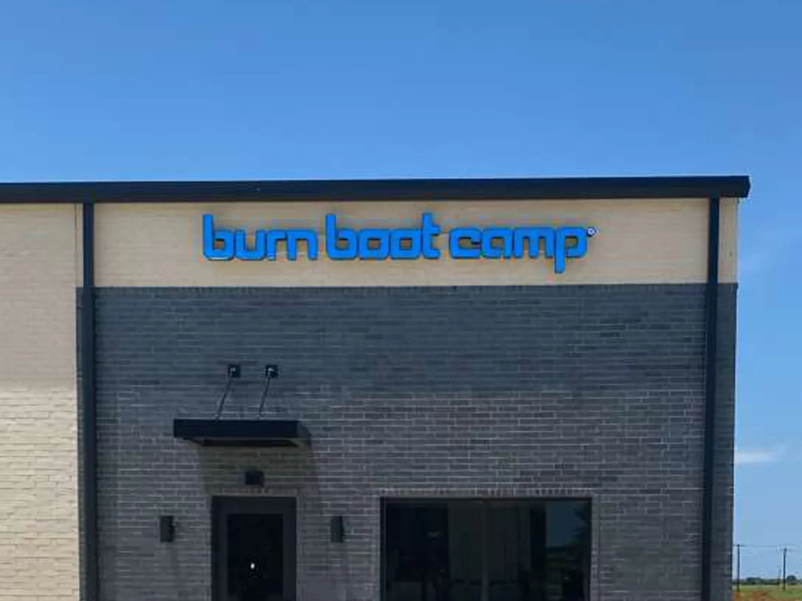 Burn Boot Camp blue channel letters across the top of a new brick building