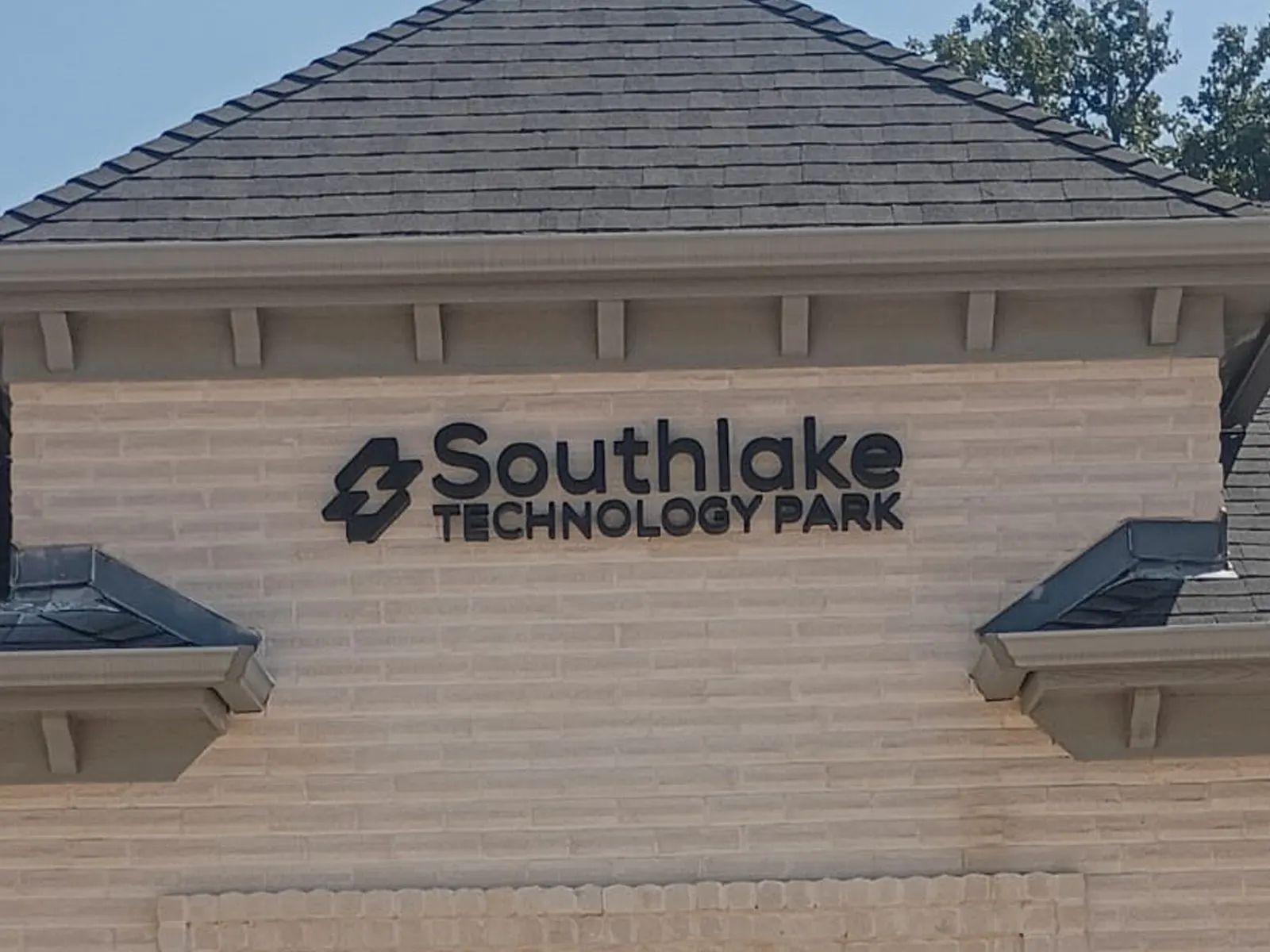 Southlake Technology Park dark dimensional letters and logo on a tan brick office building