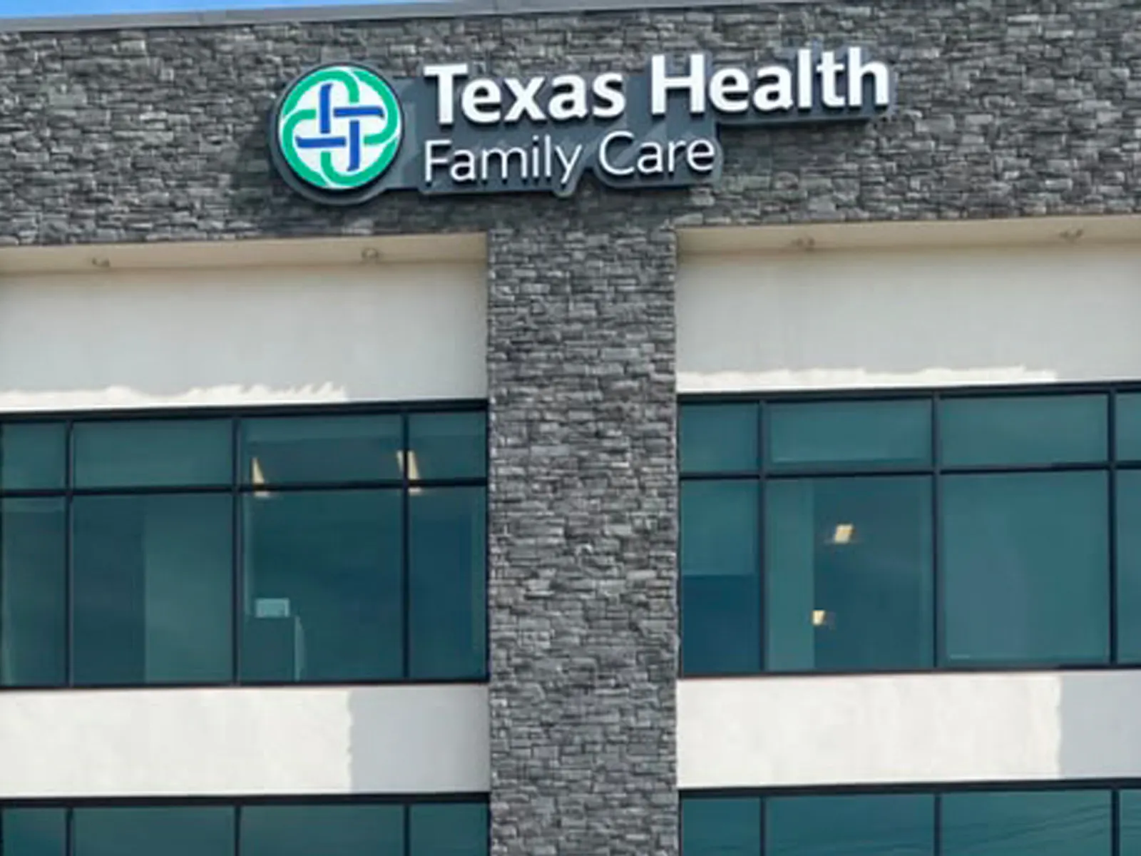 Texas Health Family Care logo and letters on a stacked stone tower of a medical building