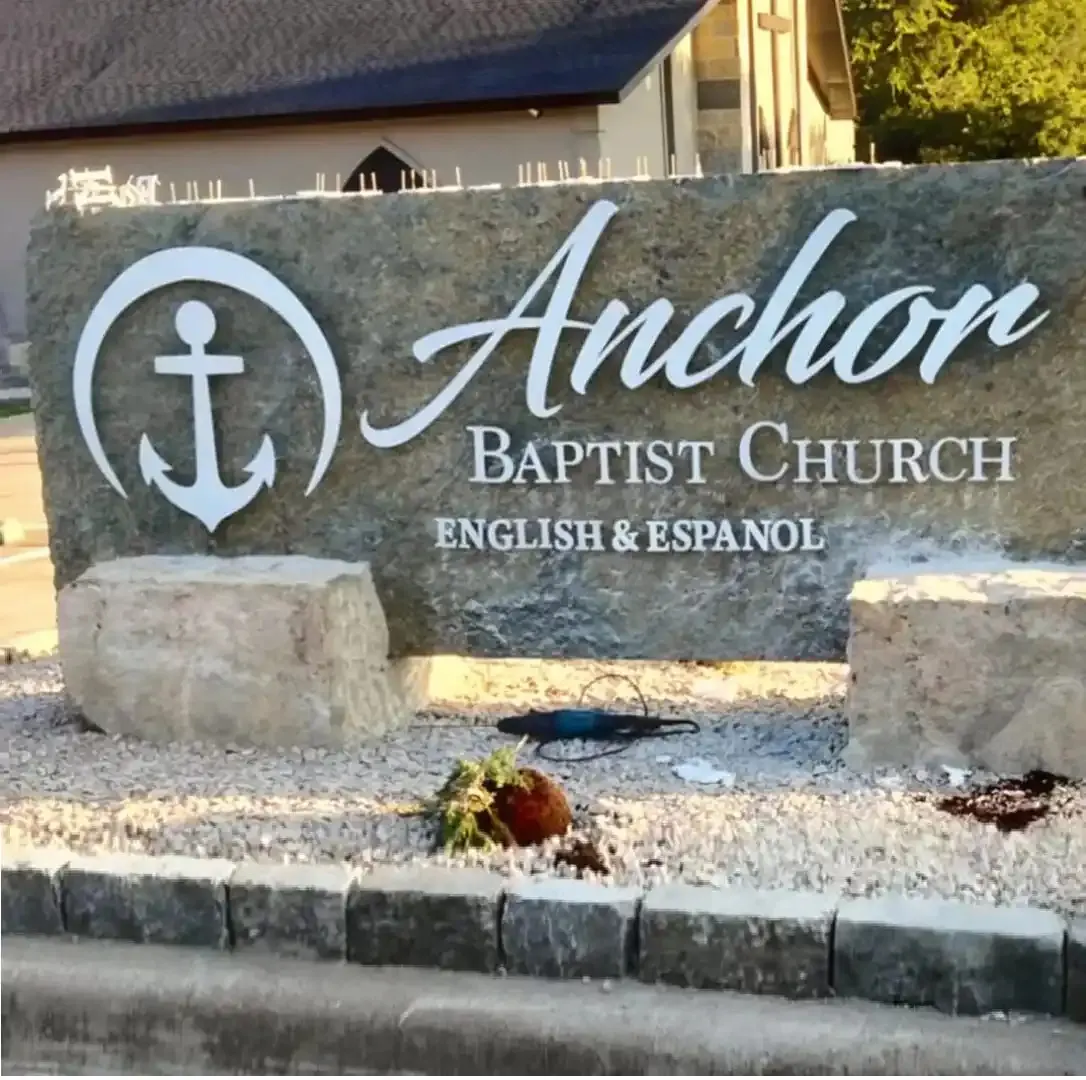 Anchor Baptist Church stone monument set in a landscaped bed