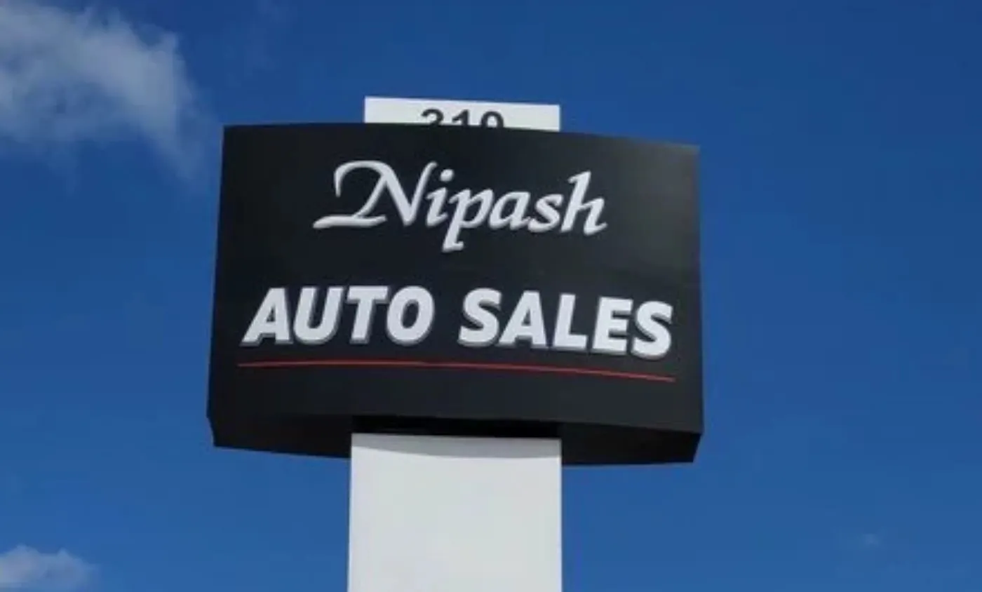 Nipash Auto Sales cabinet sign on a tall pole