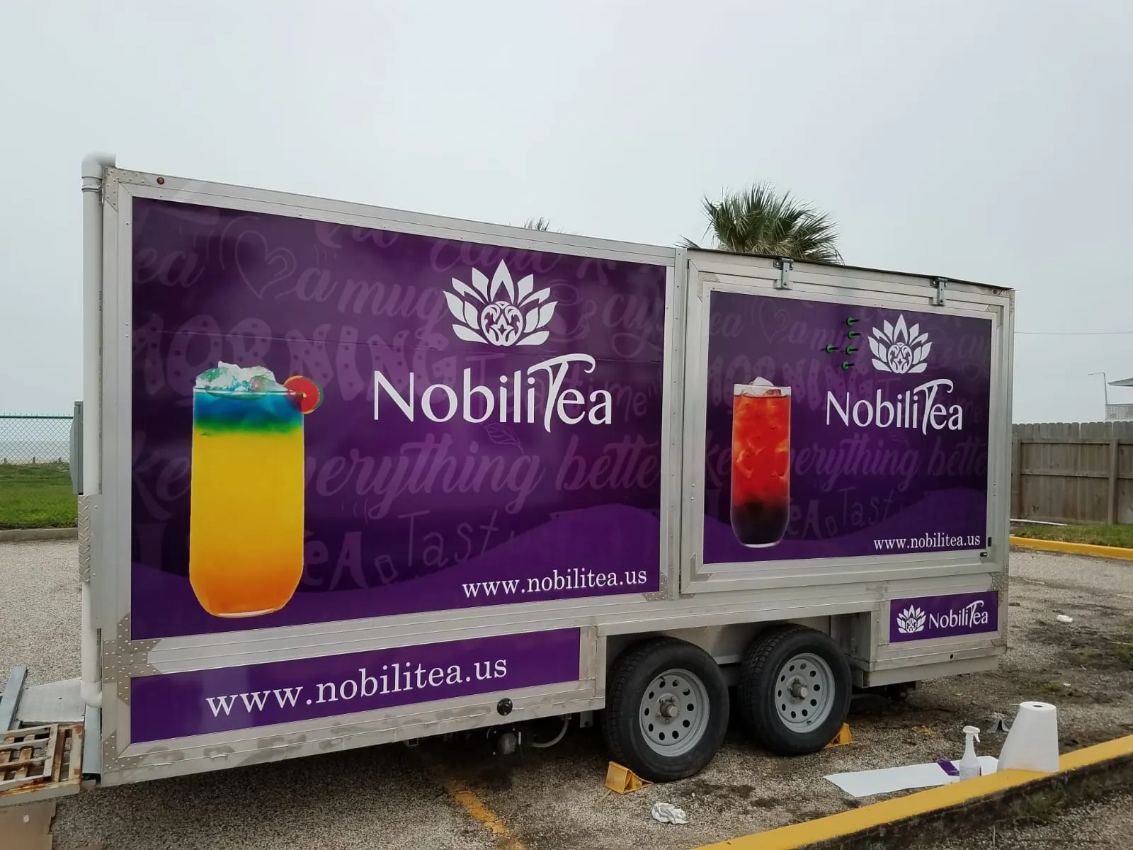 NobiliTea trailer wrapped in purple brand graphics and drink photography