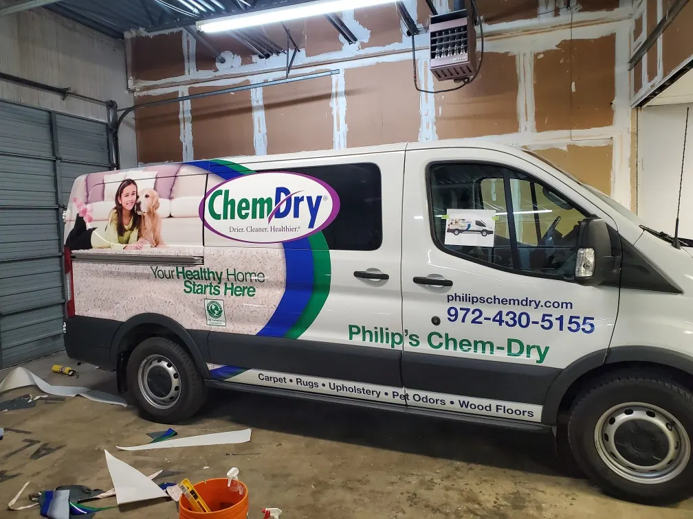 Philip's Chem-Dry van with a partial vehicle wrap inside the shop